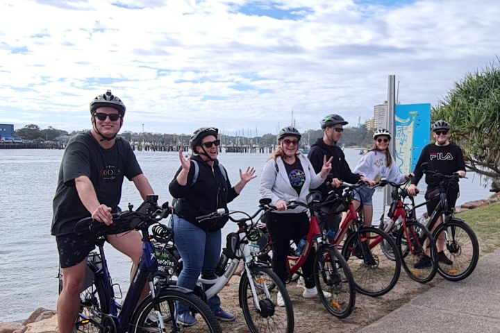 a group of people riding on the back of a bicycle