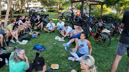 a group of people sitting at a crowded park